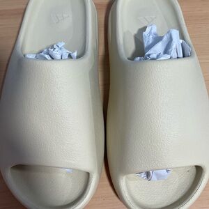 brand new yeezy slides in the shade sand size 10 in men’s